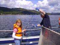Young guest catching her first fish
